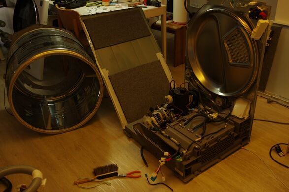 Drum and side panel out, back frame still standing with the base exposed